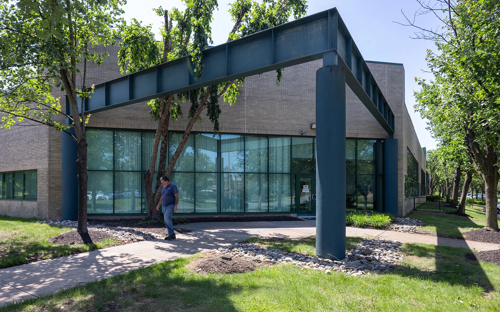 Professional business campus with architectural canopy tree shaded walkway and contemporary office exterior