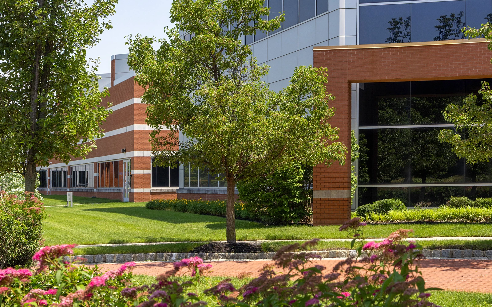 Main entrance with brick columns and glass doors at Cedar Brook corporate center campus