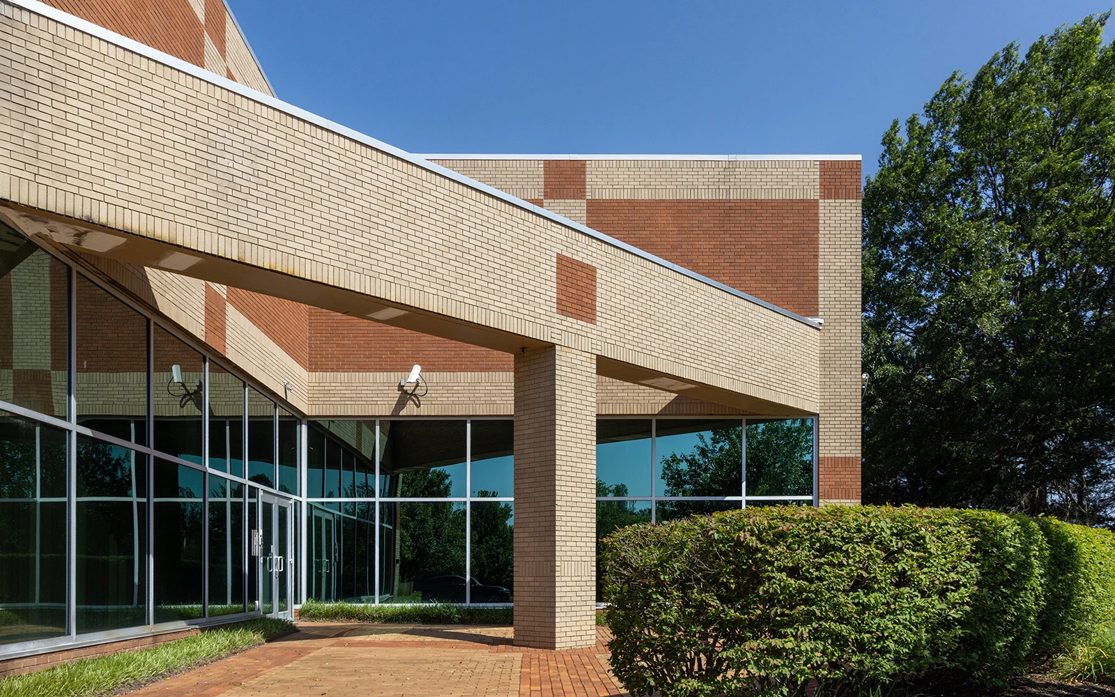 A brick office building with strong angels in the masonry
