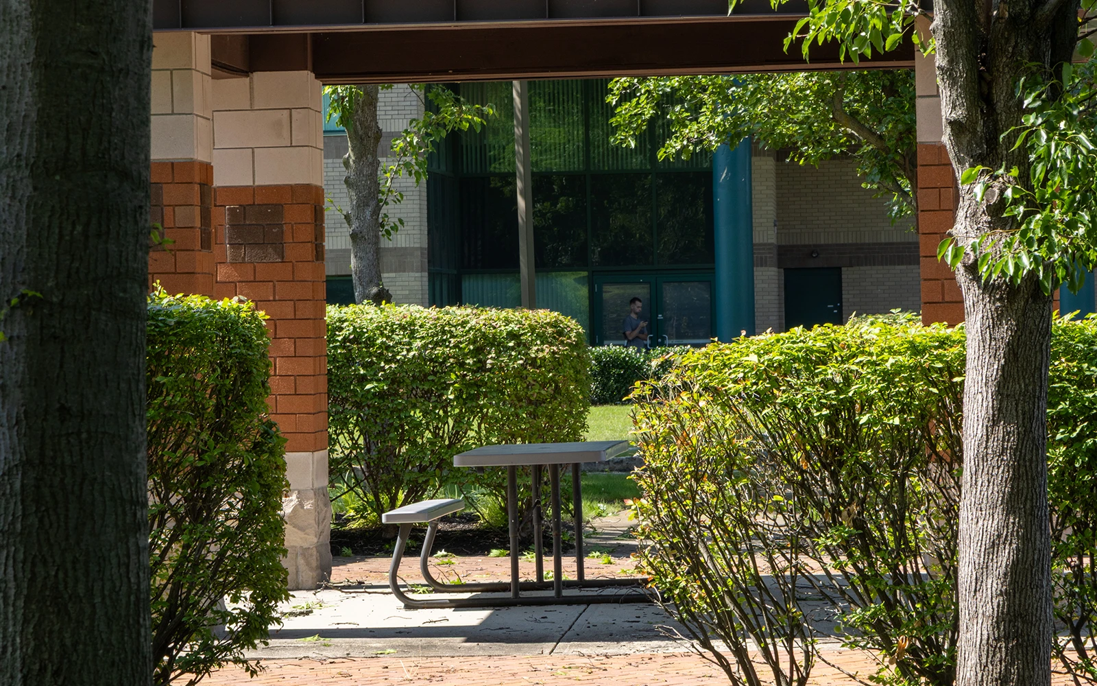 A shaded outdoor seating area on a corporate campus in Cranbury NY