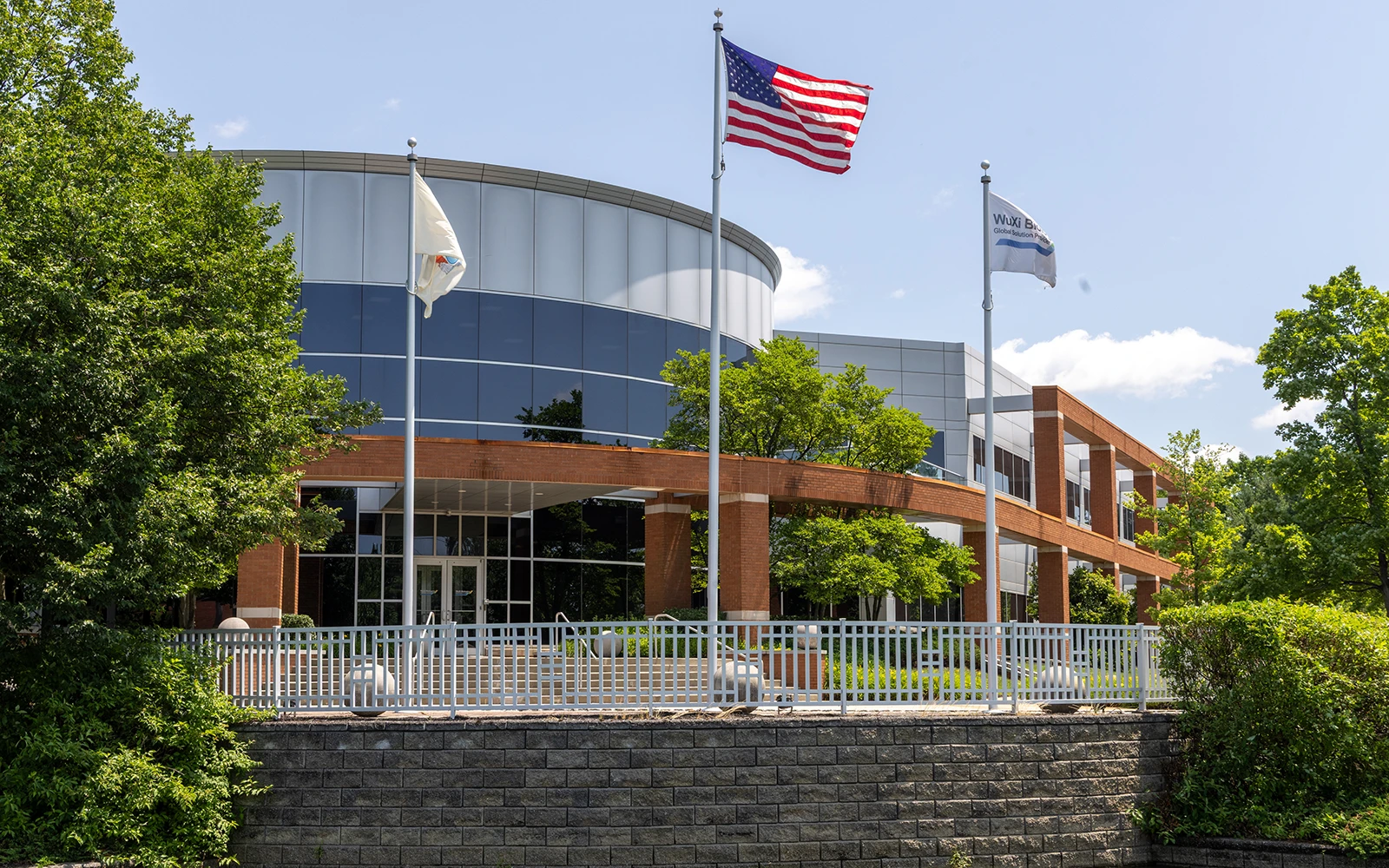 Modern office building with flags brick colonnade and landscaping at Cedar Brook corporate center