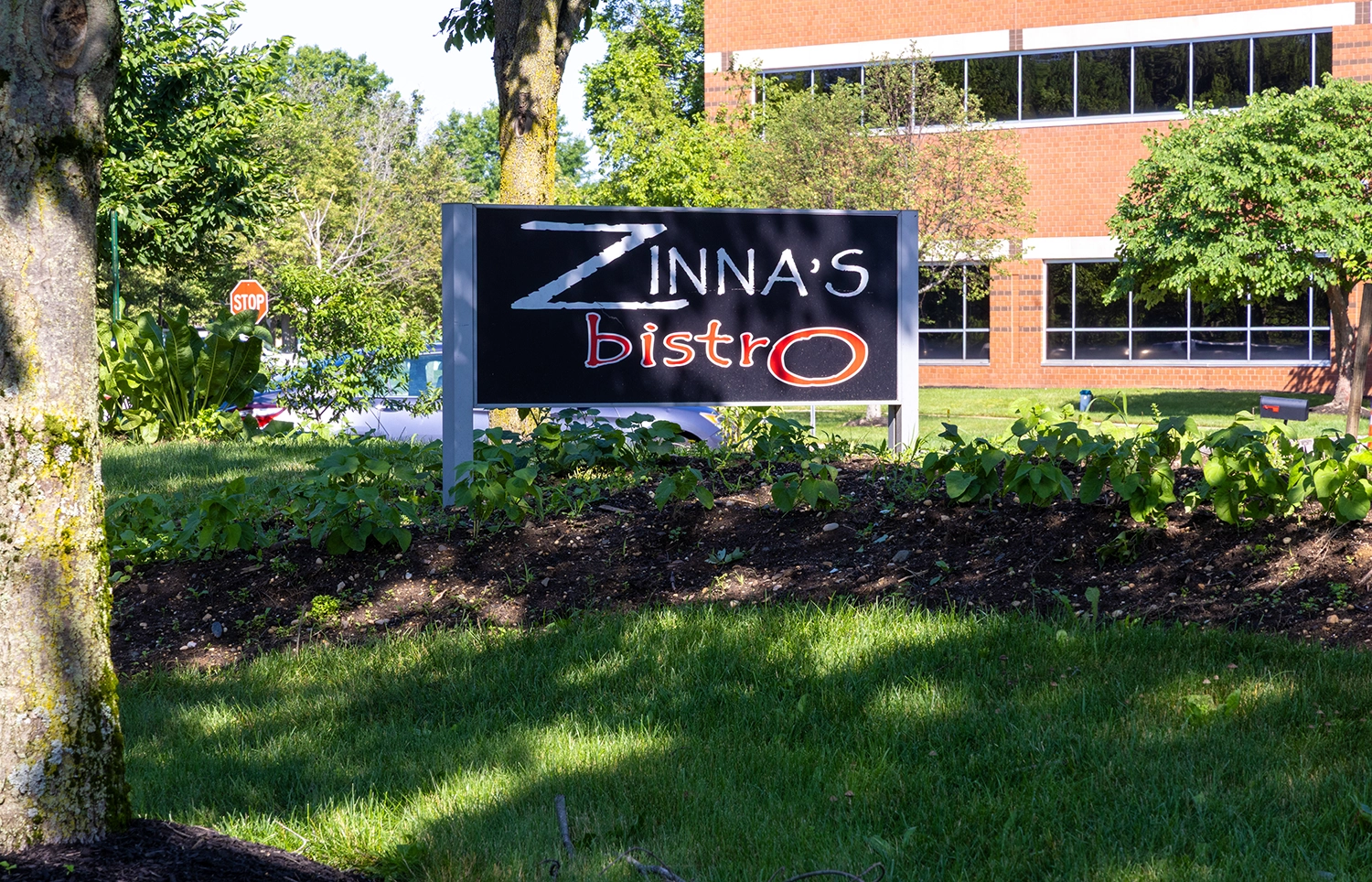 Outdoor sign for Zinna's Bistro at Cedar Brook corporate center